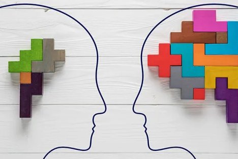 Two outlined profiles facing each other with colorful puzzle pieces forming brains.