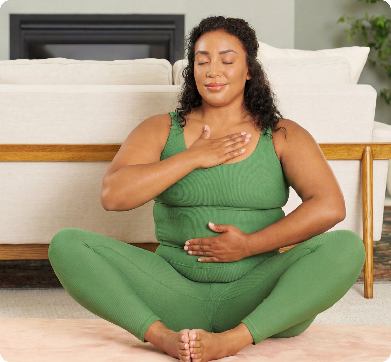 A person sitting cross‑legged on a couch with hands on their stomach and chest, practicing a calming breathing exercise to support gut balance. Used on a page explaining how stress impacts digestion and the role of doctor recommended probiotics.