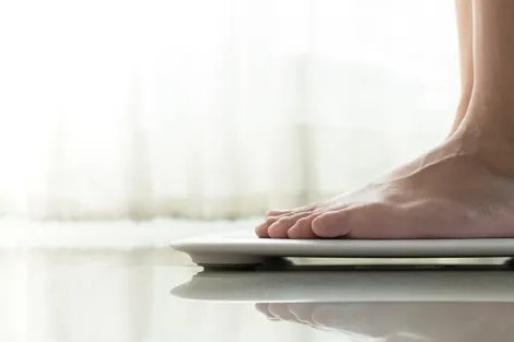 Close up of a person's feet standing on a scale
