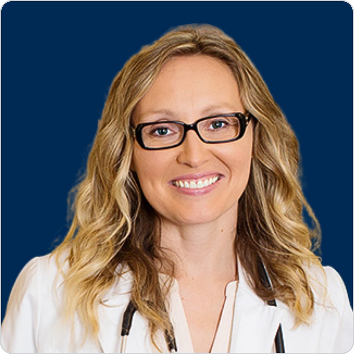 Portrait of Dr. Jen Stagg, ND, Metagenics naturopathic doctor and clinical gut health expert, wearing a white coat against a dark blue background.