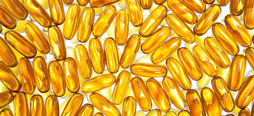 A pile of omega-3 capsules on a light table