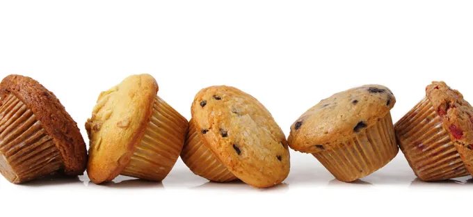 A stock image showing several different muffin flavors in a row.