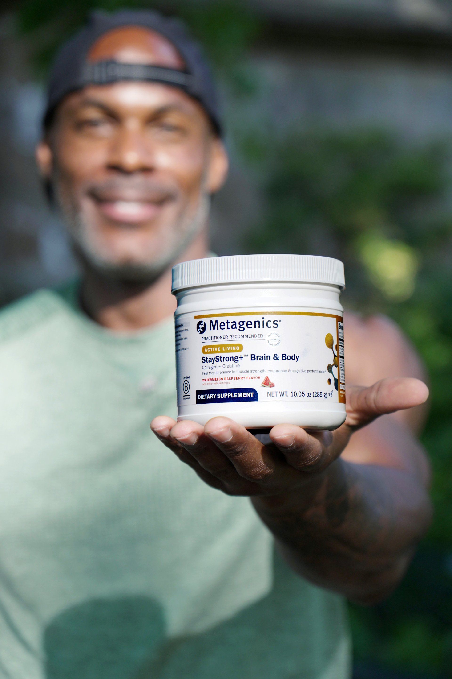 Adrian Williams holding metagenics staystrong brain and body
