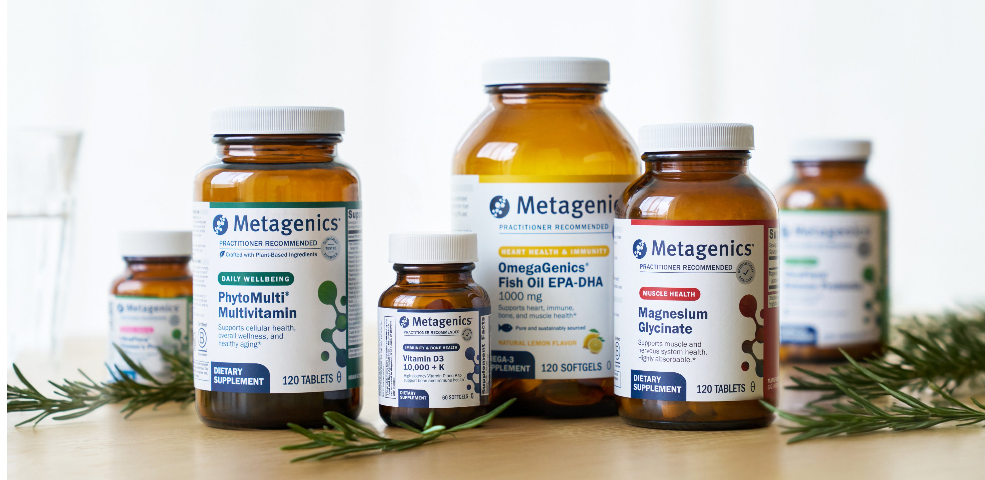 Metagenics Black Friday hero banner showing multivitamins, vitamin D, omegas, and probiotics arranged on a kitchen counter with bright natural light.
