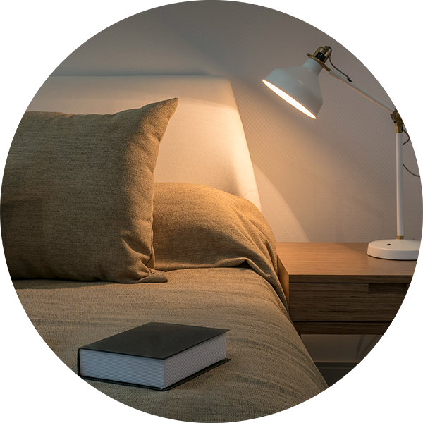 Close up of a cosy bed and bedside table
