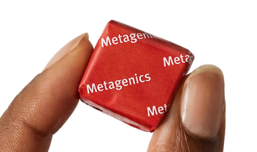 Hand holding a Metagenics StayStrong+ 4-in-1 Collagen Whole Body Chew against a gold background.