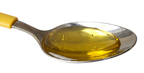 A silver spoon filled with golden OmegaGenics liquid fish oil 
