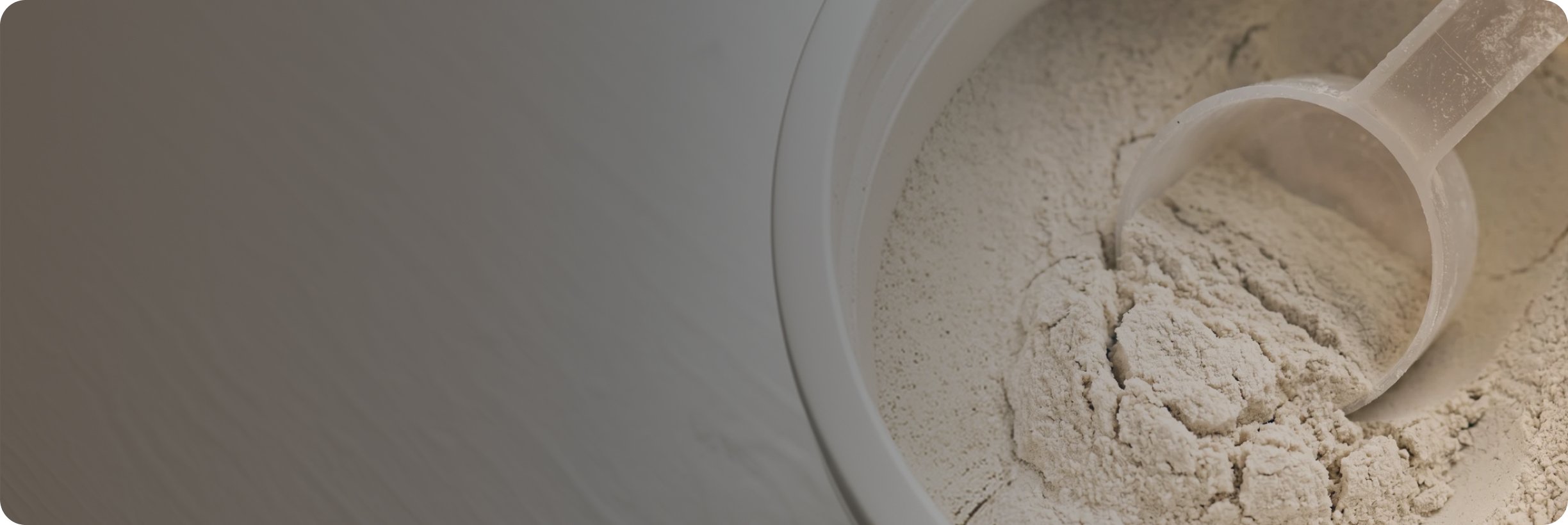 Powdered supplement ingredient and scoop on a neutral background, representing support for bone, joint, and mobility health.