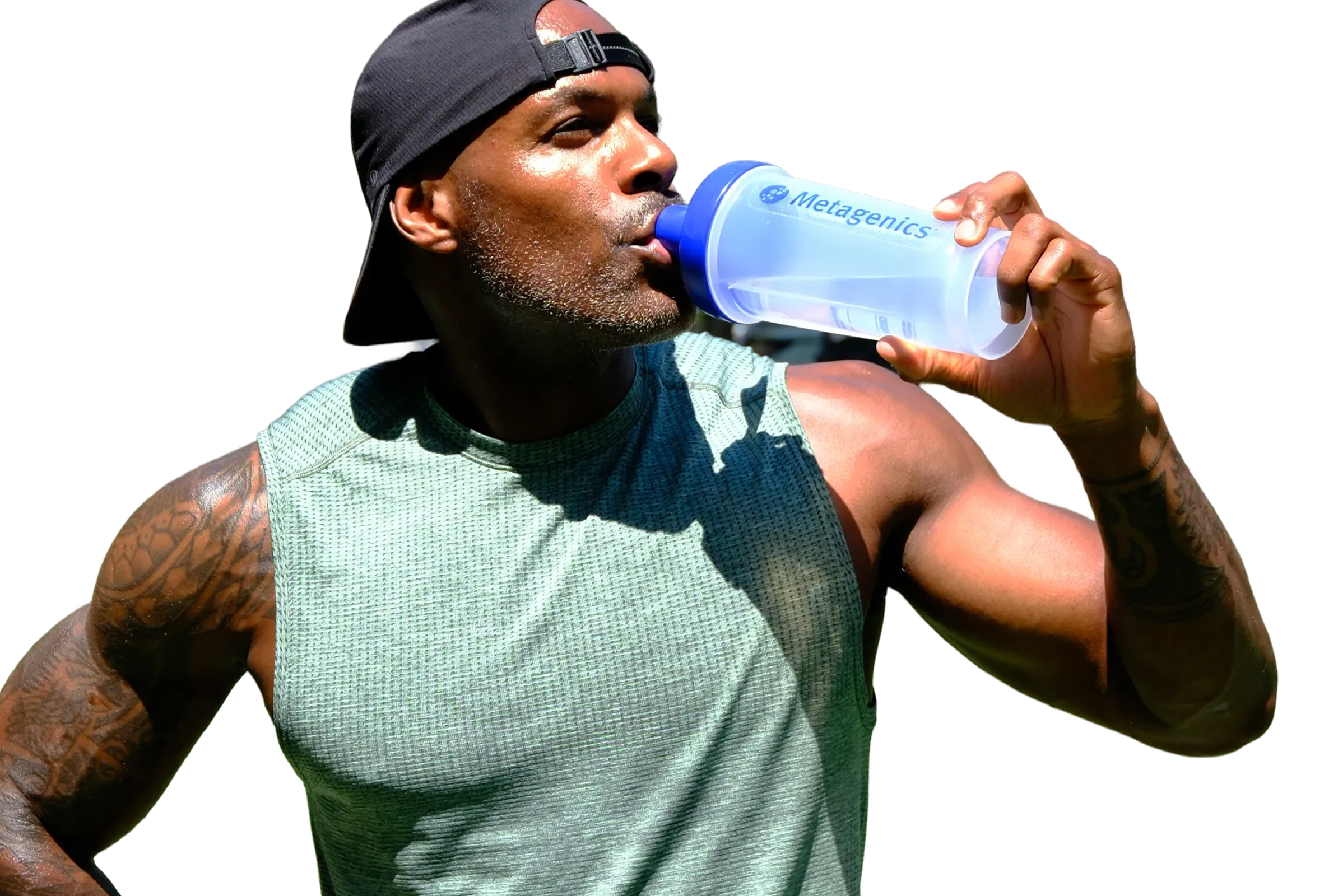 Adrian Williams drinks from a Metagenics shaker bottle while wearing a sleeveless green top and a backward black cap, highlighting the active lifestyle theme of the Metagenics StayStrong+ campaign.