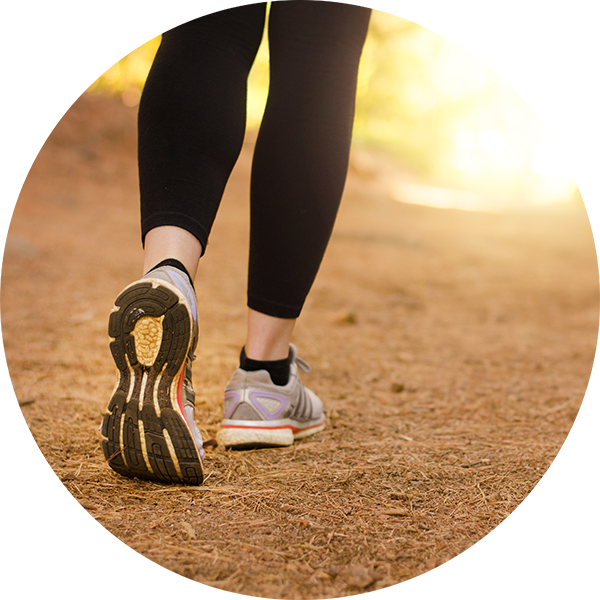 Close up of a walker's legs and feet on an outdoor trail