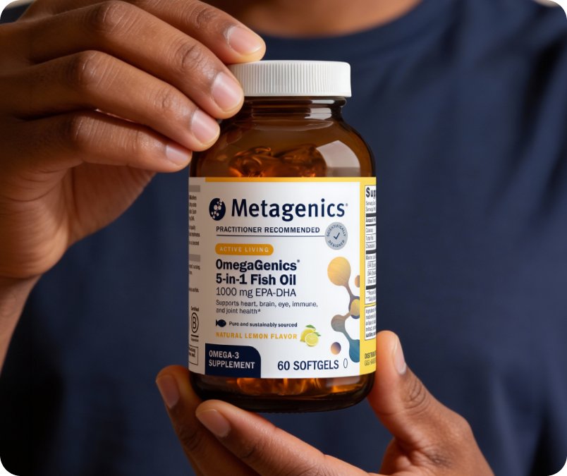  A person holding a bottle of Metagenics OmegaGenics EPA-DHA 1000 in their hand, shown on the Metagenics OmegaGenics landing page.