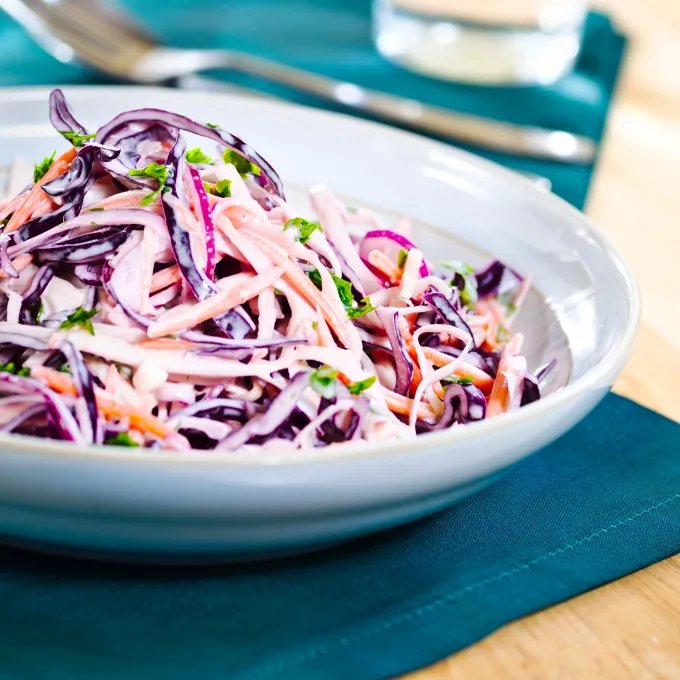 Closeup of a bowl of colorful cabbage and carrot slaw