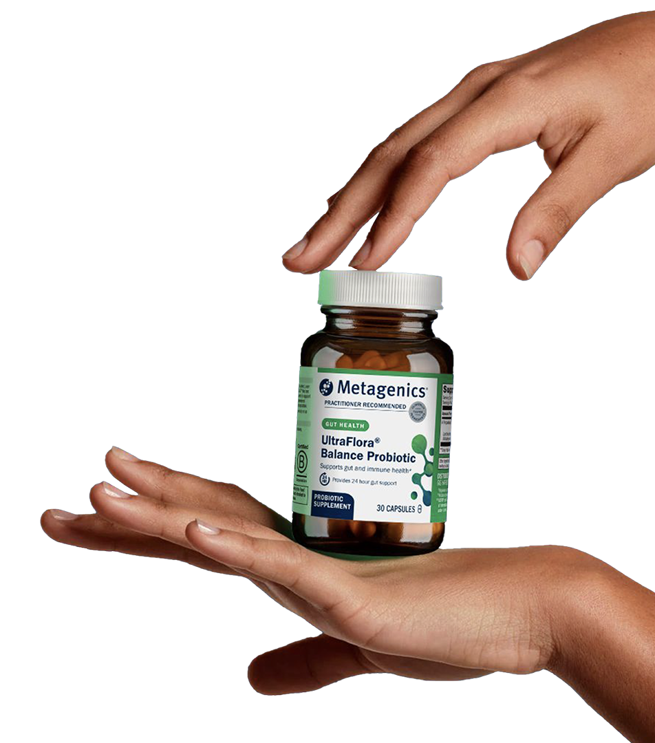 Two hands gently frame a bottle of Metagenics UltraFlora® Balance Probiotic, highlighting the product's trusted support for gut and immune health in a minimal, stylized presentation.