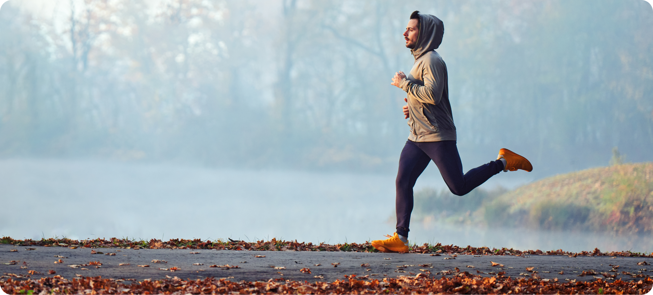 Person jogging outdoors on a cool fall morning, highlighting active lifestyle habits and Fall Wellness support.