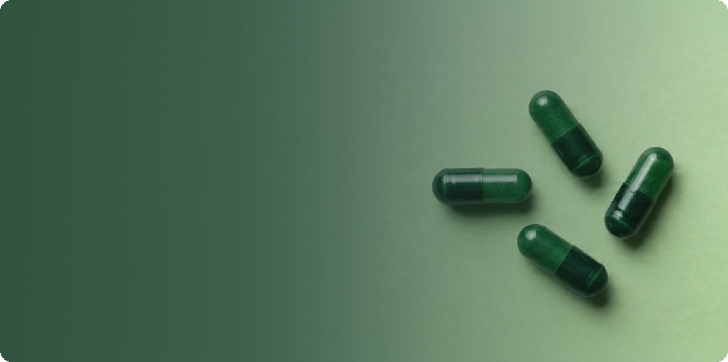Green supplement capsules arranged on a soft green background, representing digestive health and probiotic support.
