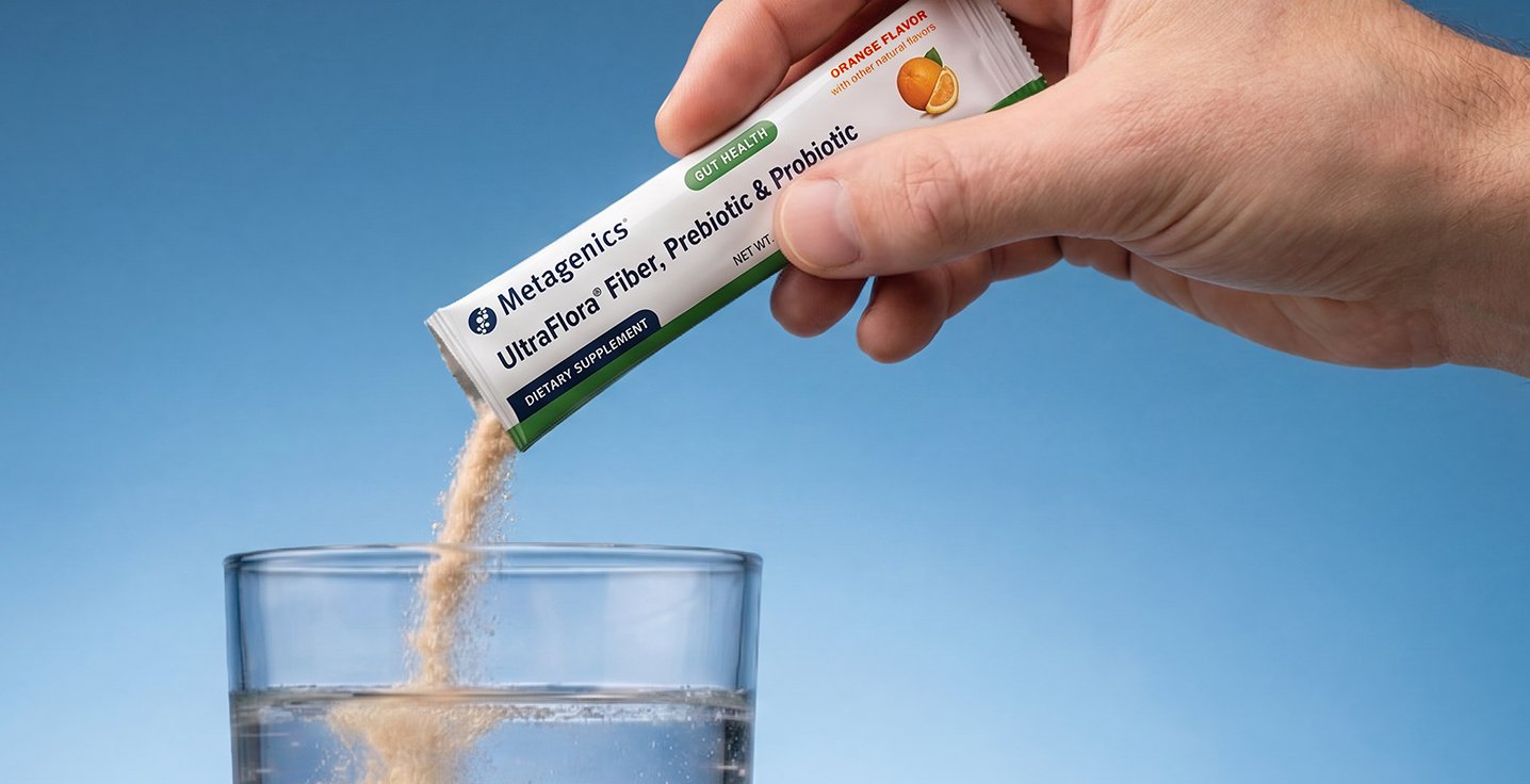 Gut health vitamins & supplements featuring Metagenics UltraFlora Fiber, Prebiotic & Probiotic powder being poured into a glass of water.