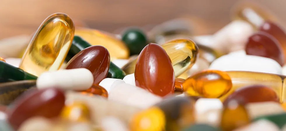 A close up photograph of a selection of capsules and tablets