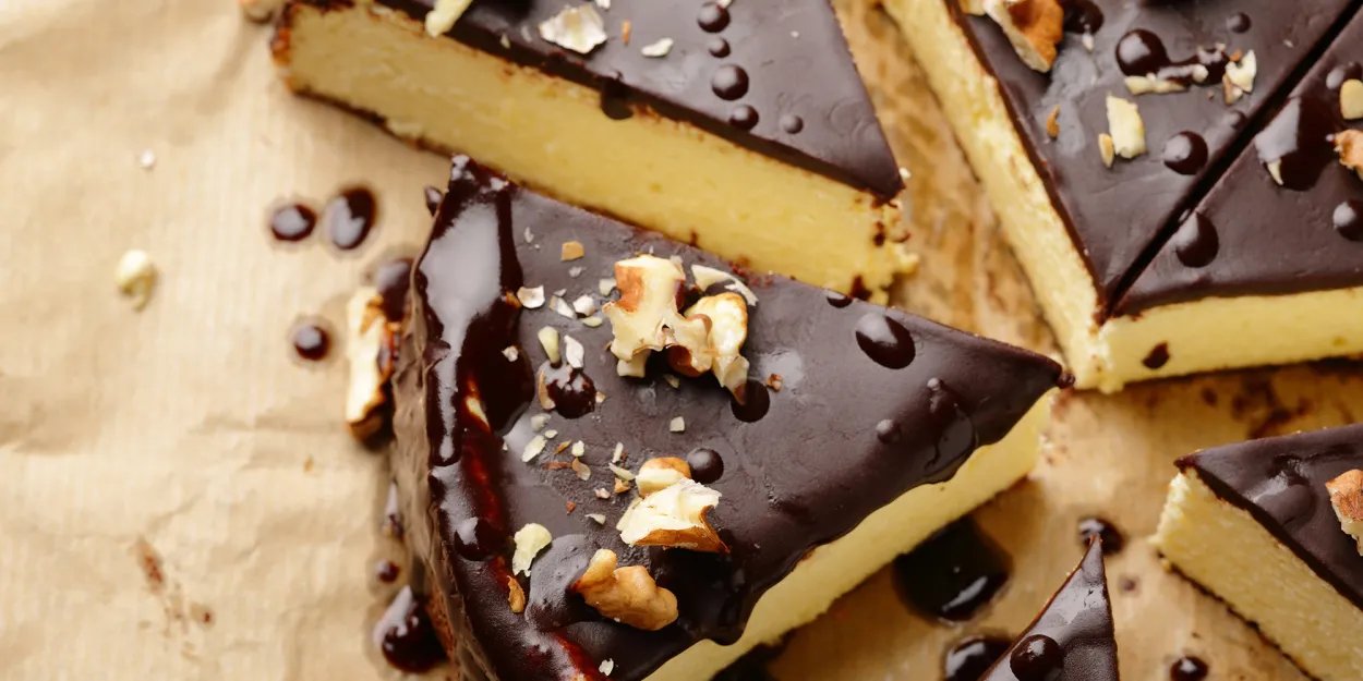 Overhead image of a sliced peanut butter cheesecake with chocolate frosting