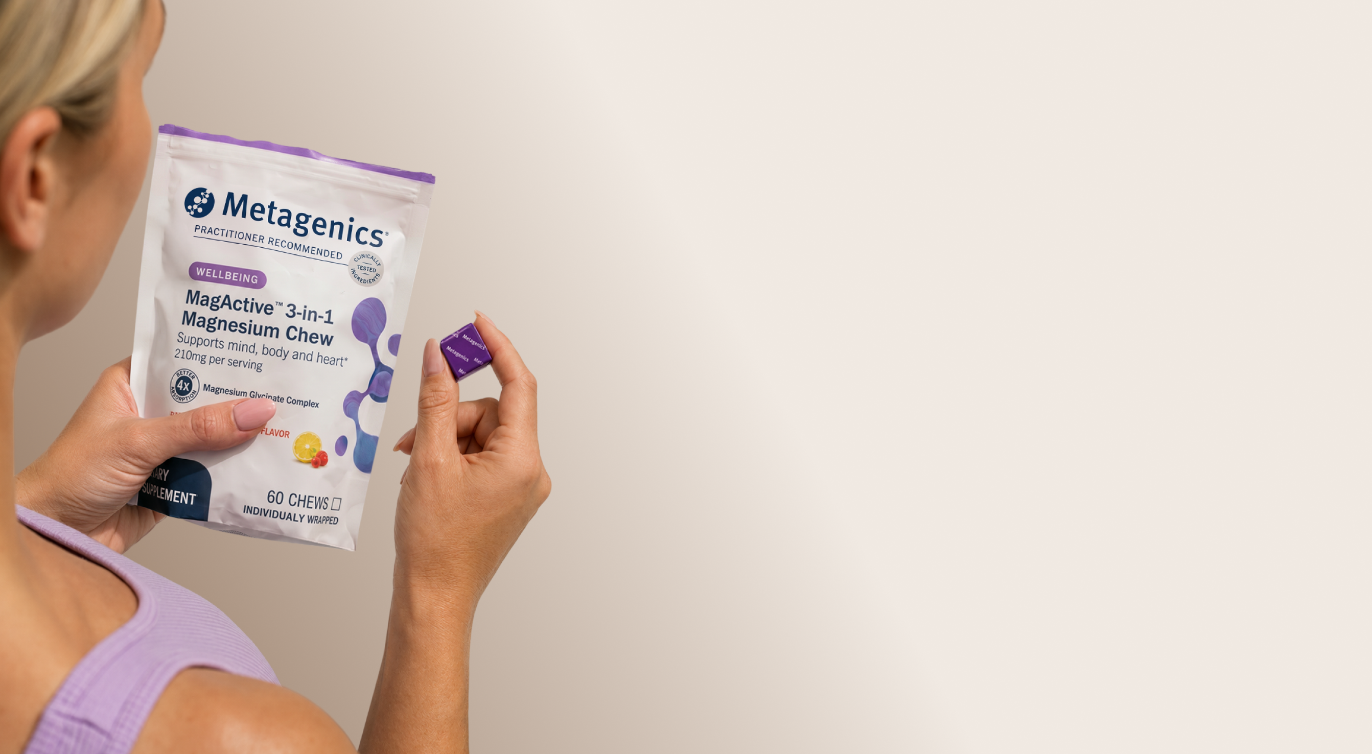 Person holding a bag of Metagenics MagActive® 3-in-1 Magnesium Chews and an individually wrapped chew, highlighting a return to healthy daily routines and wellness habits during seasonal transitions.
