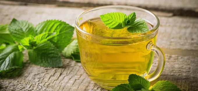 Peppermint tea and fresh mint leaves for digestive health