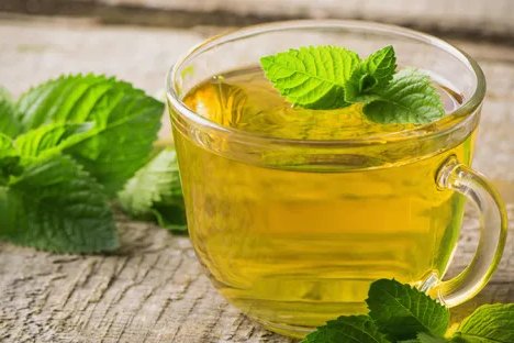 Peppermint tea and fresh mint leaves for digestive health