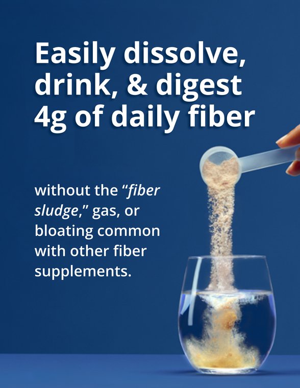 A scoop of powder pours into a clear glass of water against a blue background, illustrating how UltraFlora® Fiber + Prebiotics + Probiotics by Metagenics easily dissolves without clumping, showcasing this Fiber supplement powder as a gentle, no-sludge option for daily digestive support.