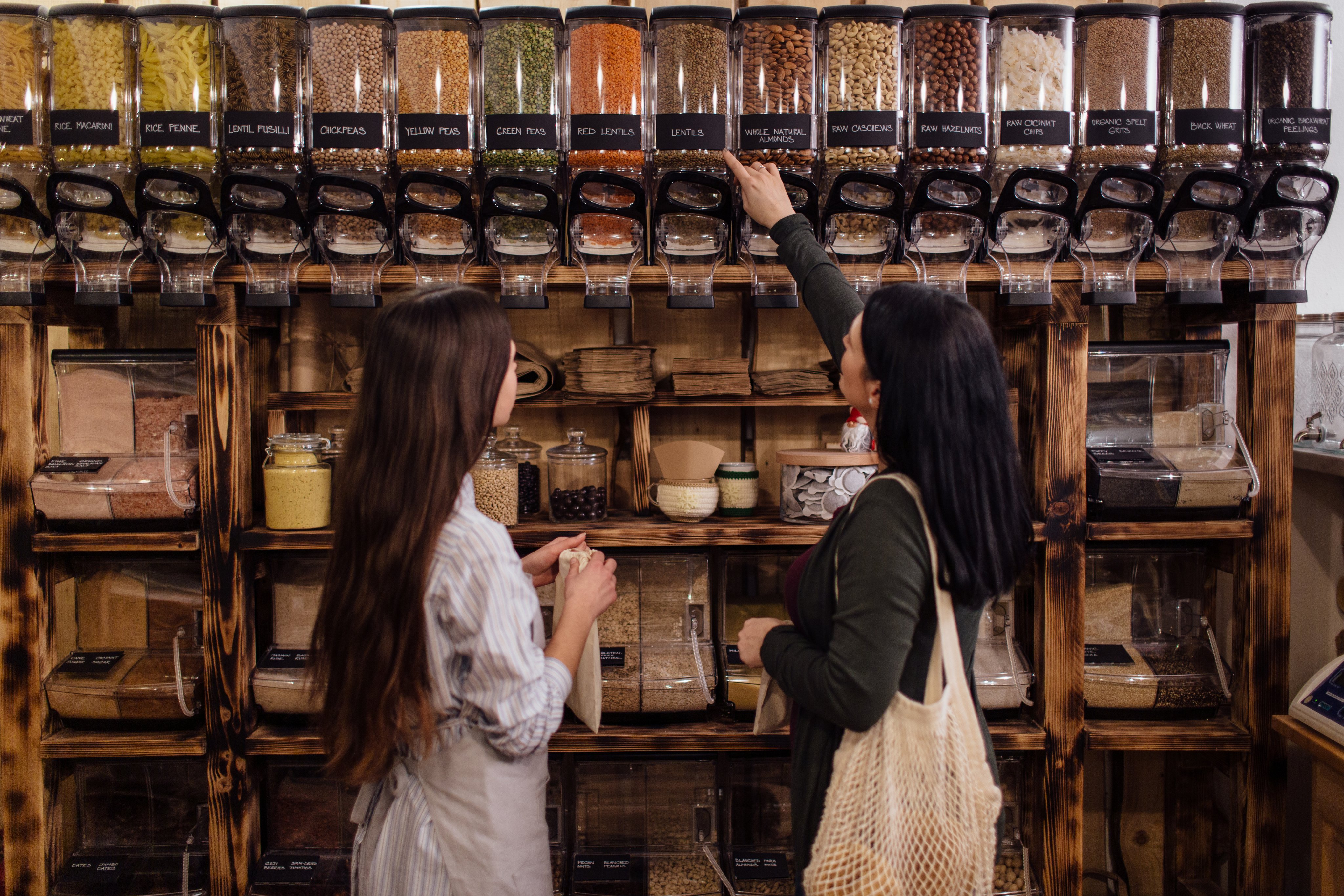 Shopkeeper helping customer in packaging free shop.