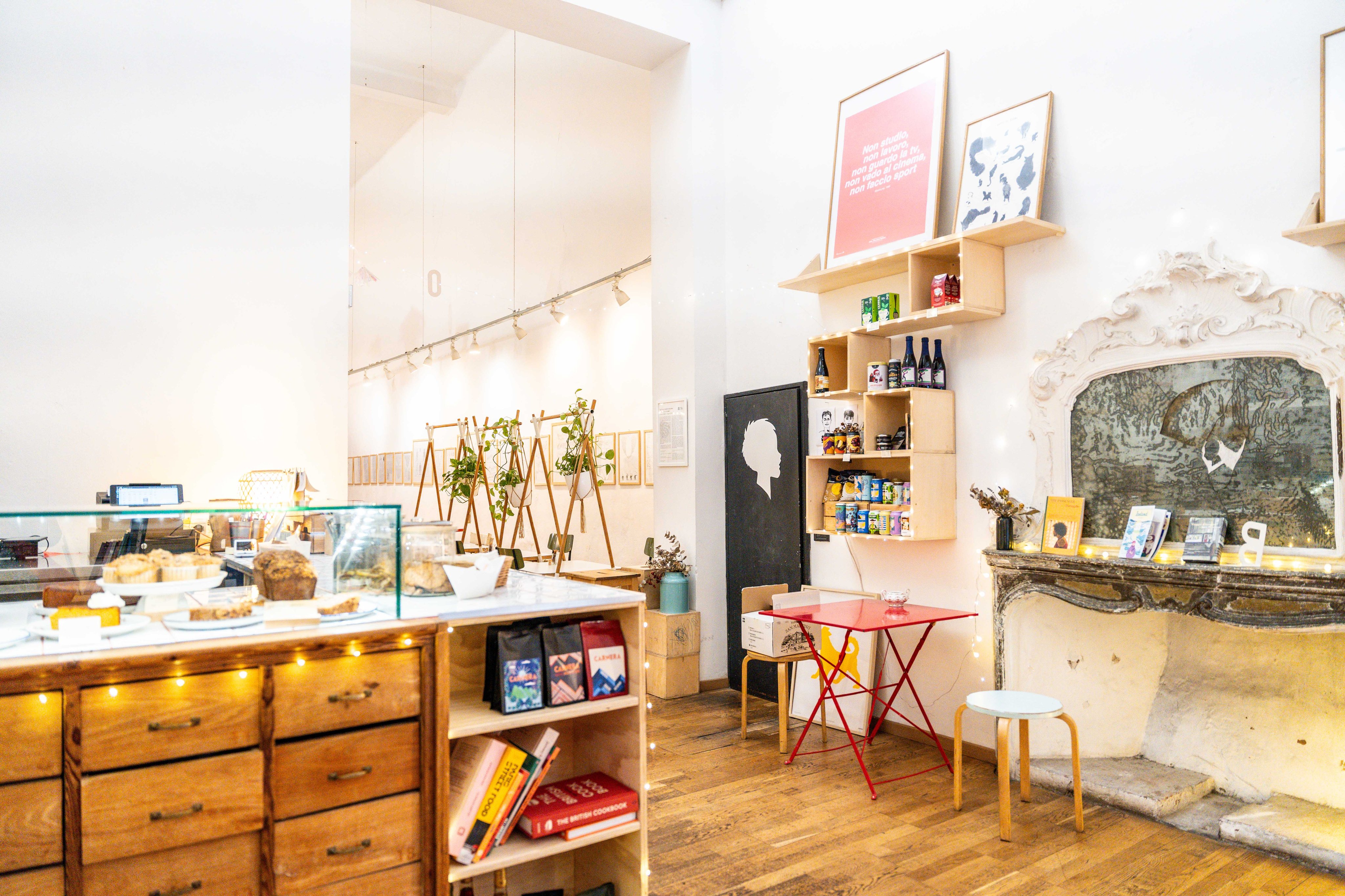 Bright cafe with vintage charm, marble counter, wooden shelves and fireplace