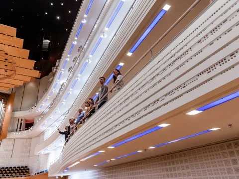View of the concert hall KKL Luzern. People standing on a balcony in the concert hall.