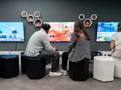 Man and woman playing Mario Kart.