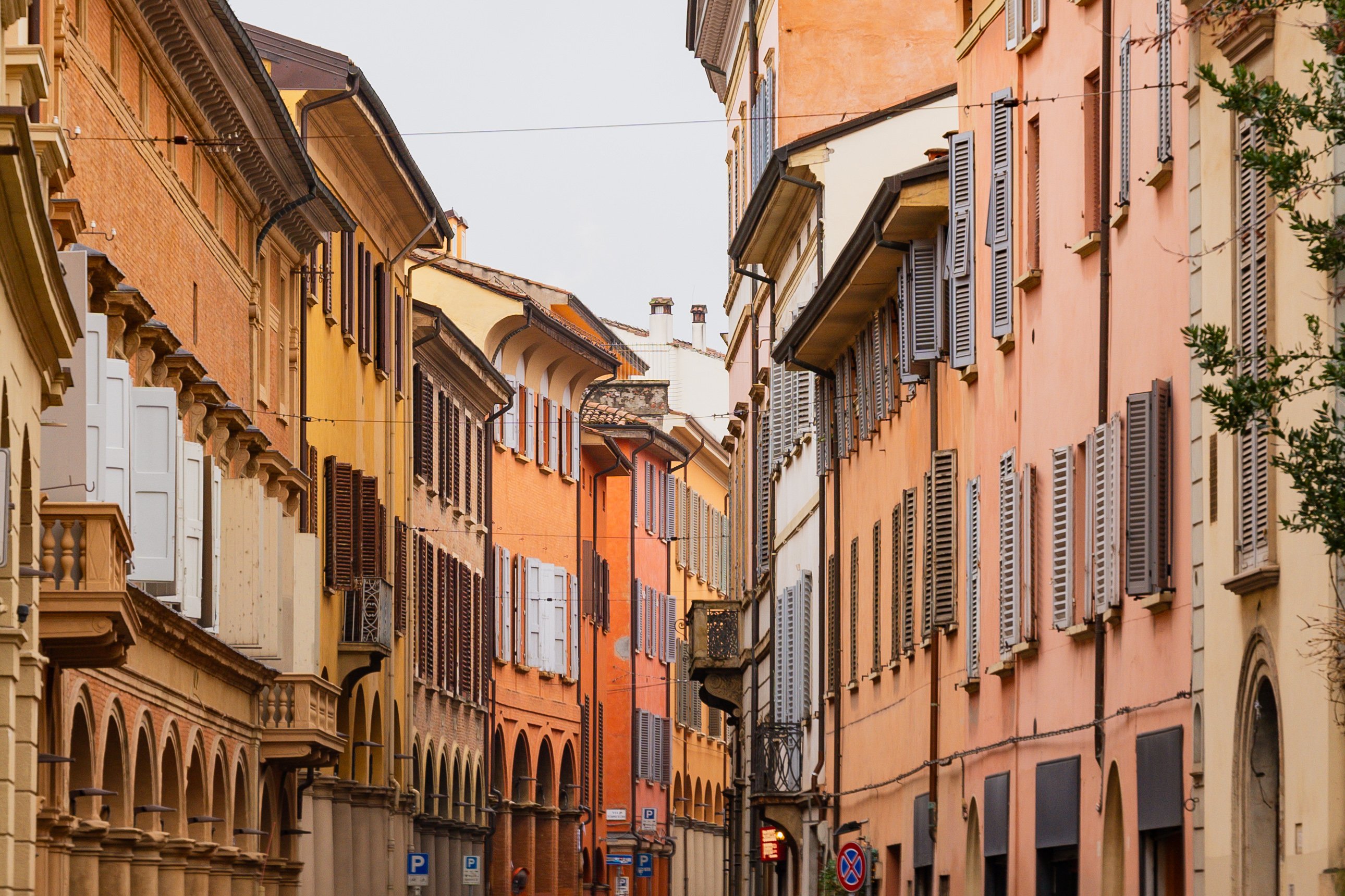 Narrow alley with colourful facades and wooden shutters