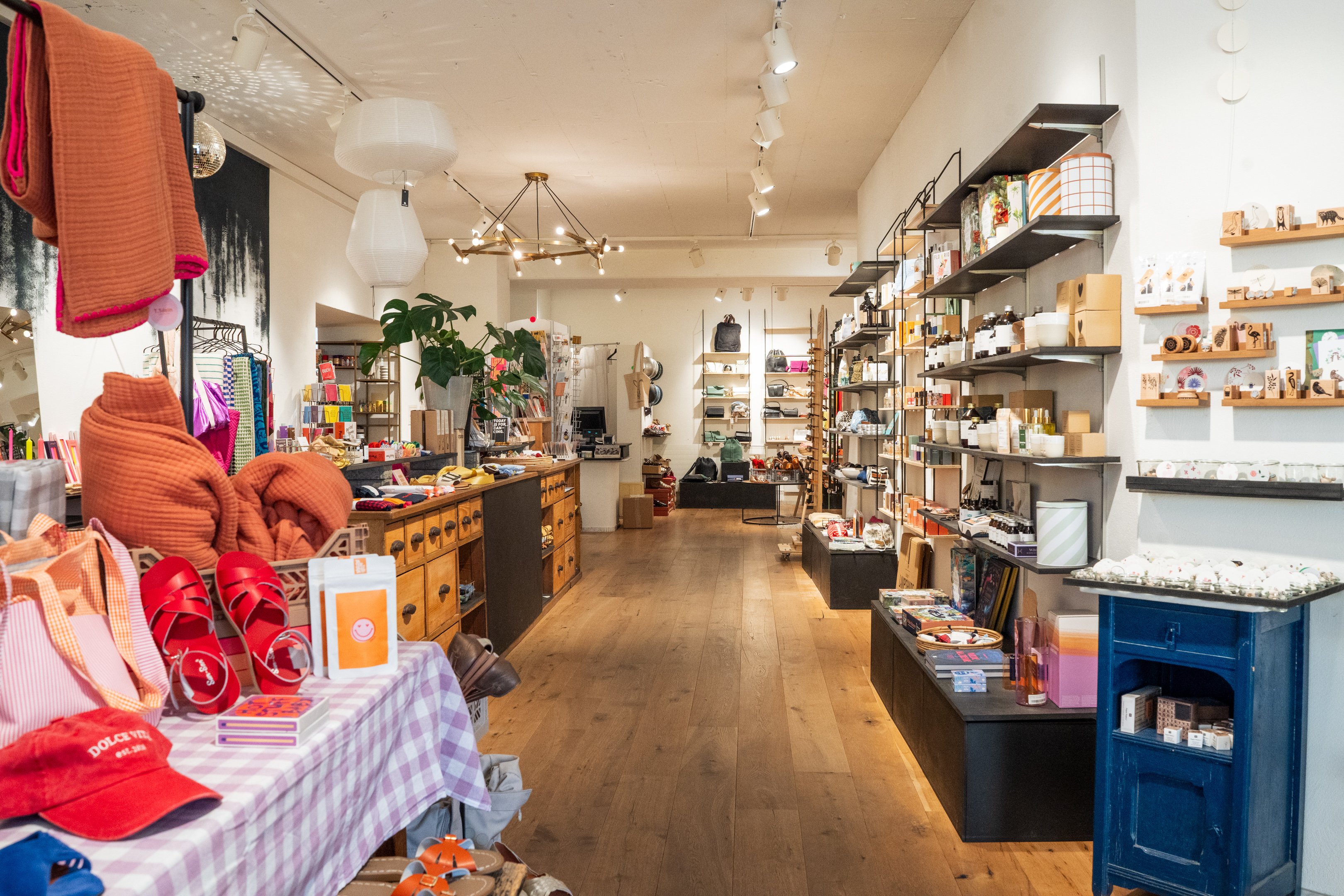 Couloir avec des étagères à droite et à gauche, remplies d’objets cadeaux.