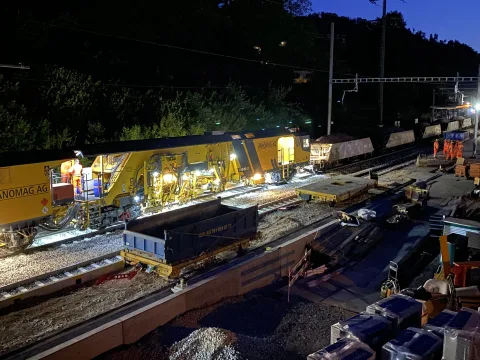 Une bourreuse lors de travaux de nuit à la gare de Grellingen.