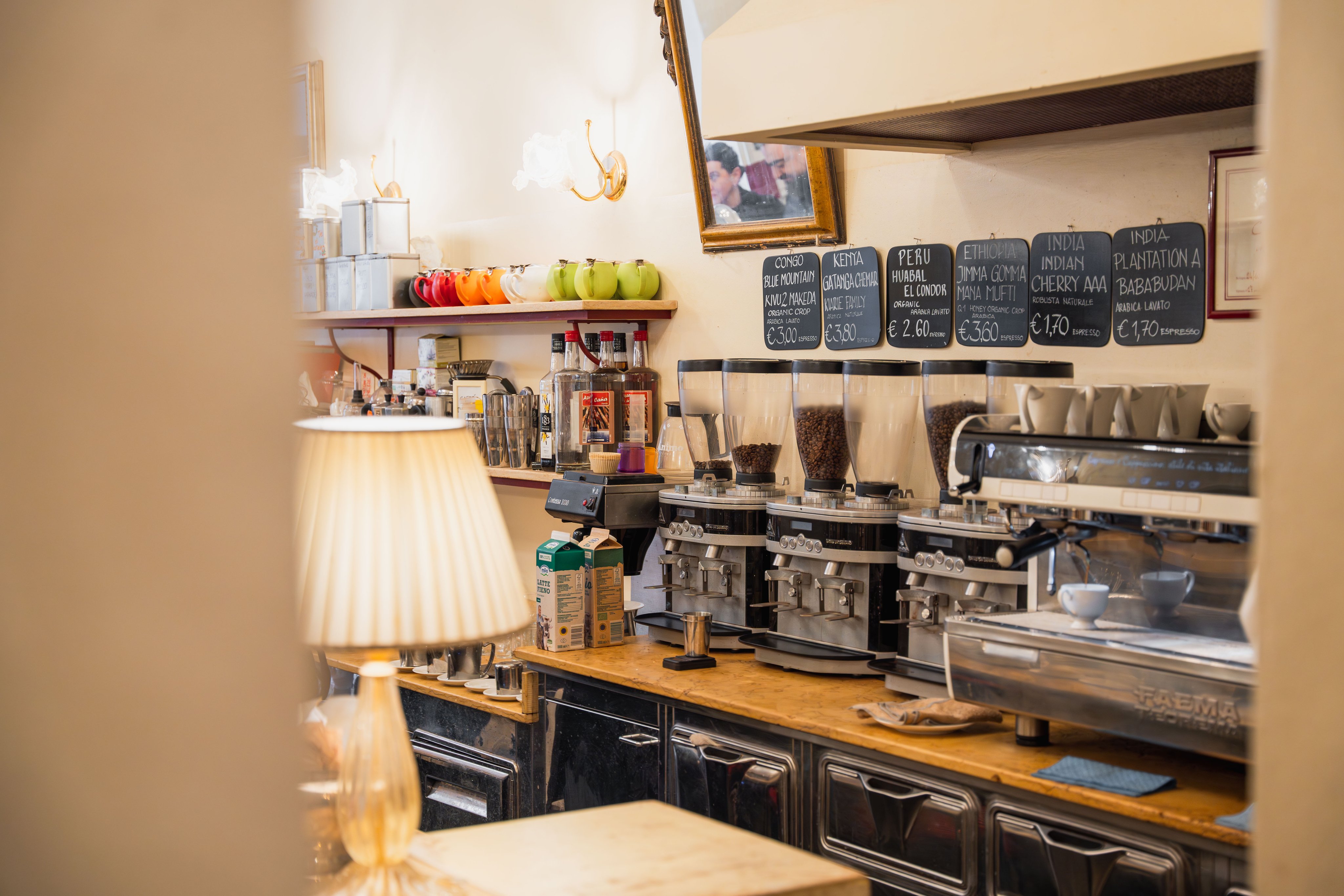 Cosy espresso bar with coffee grinders, sieve machine and tables
