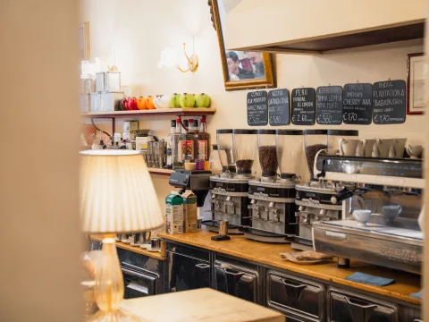 Cosy espresso bar with coffee grinders, sieve machine and tables