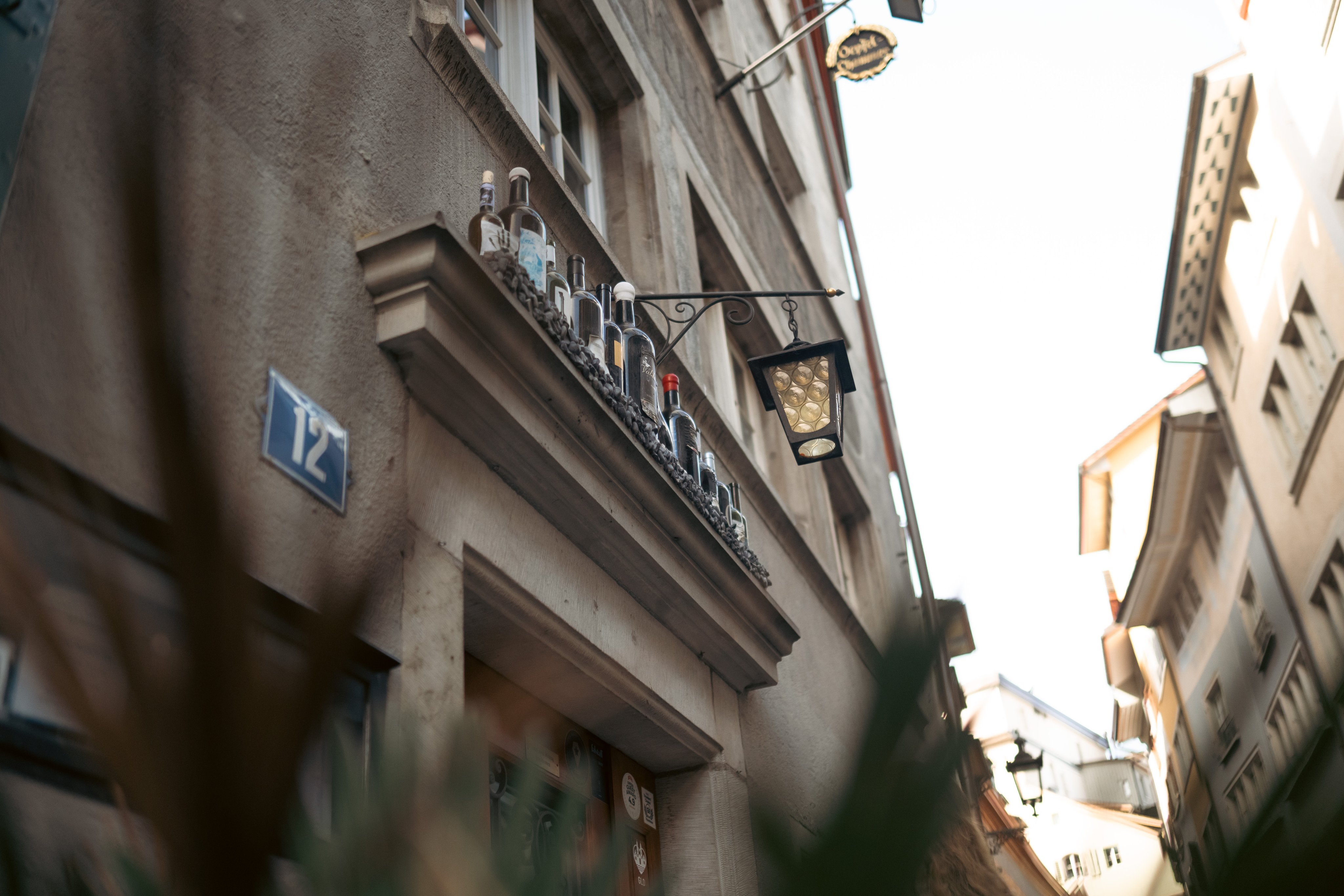 Une vieille lanterne au gaz suspendue à la façade d’une maison, au-dessus d’une porte.  