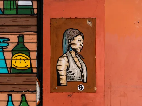 Graffiti on a house wall with a woman