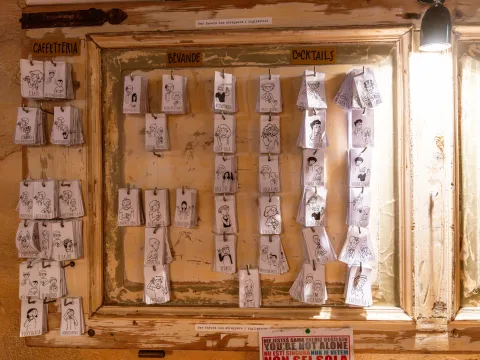 Illustrated cards with characters, hanging on a wall