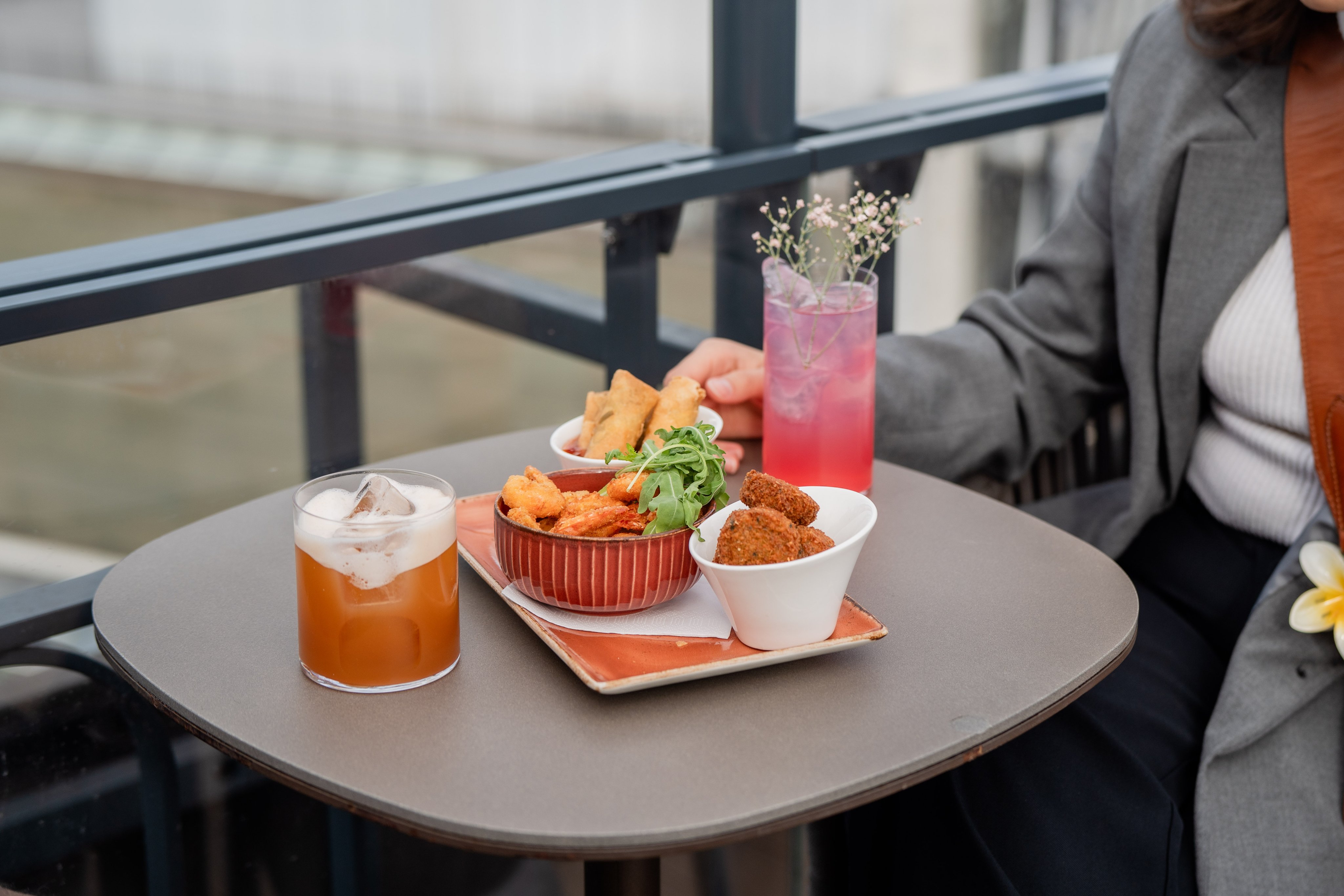 Cocktails and finger food on a table.