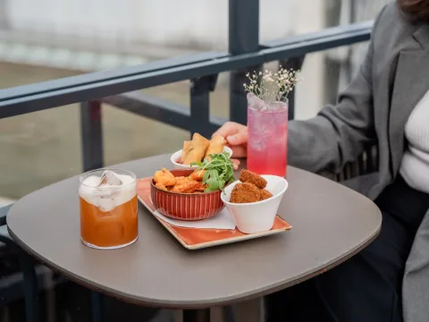 Cocktails and finger food on a table.