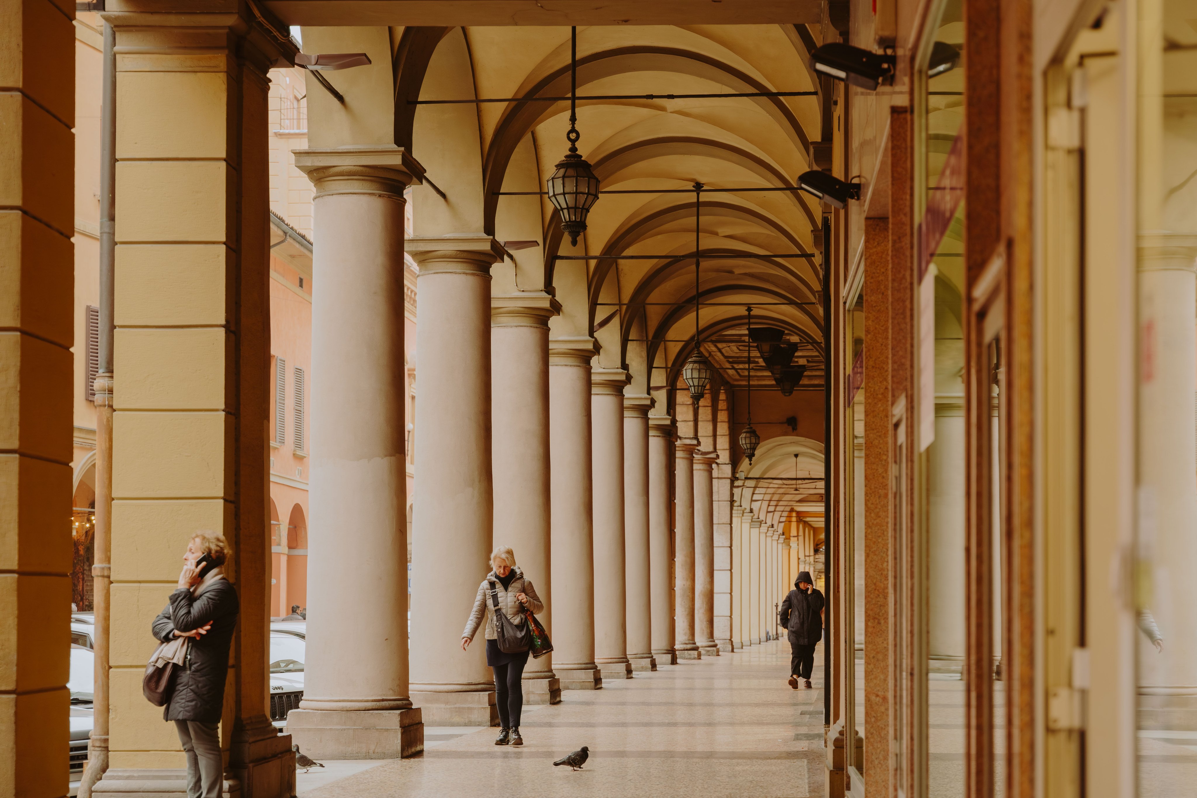 Arcade with people in Bologna