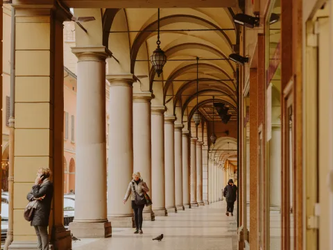Arcade with people in Bologna