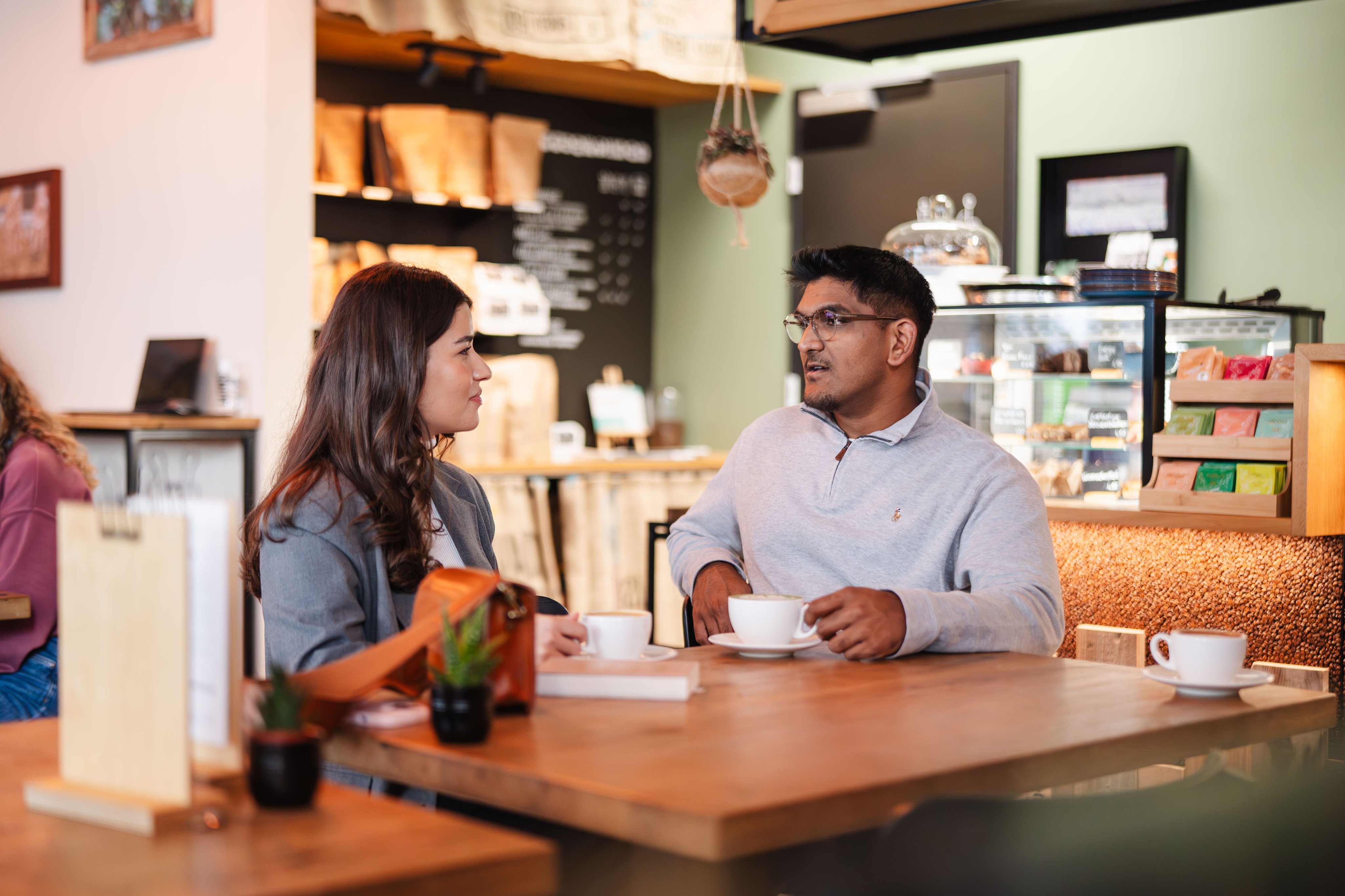 A man and a woman drinking coffee.