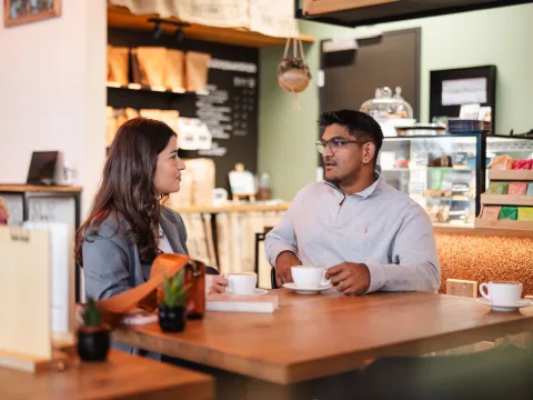 A man and a woman drinking coffee.