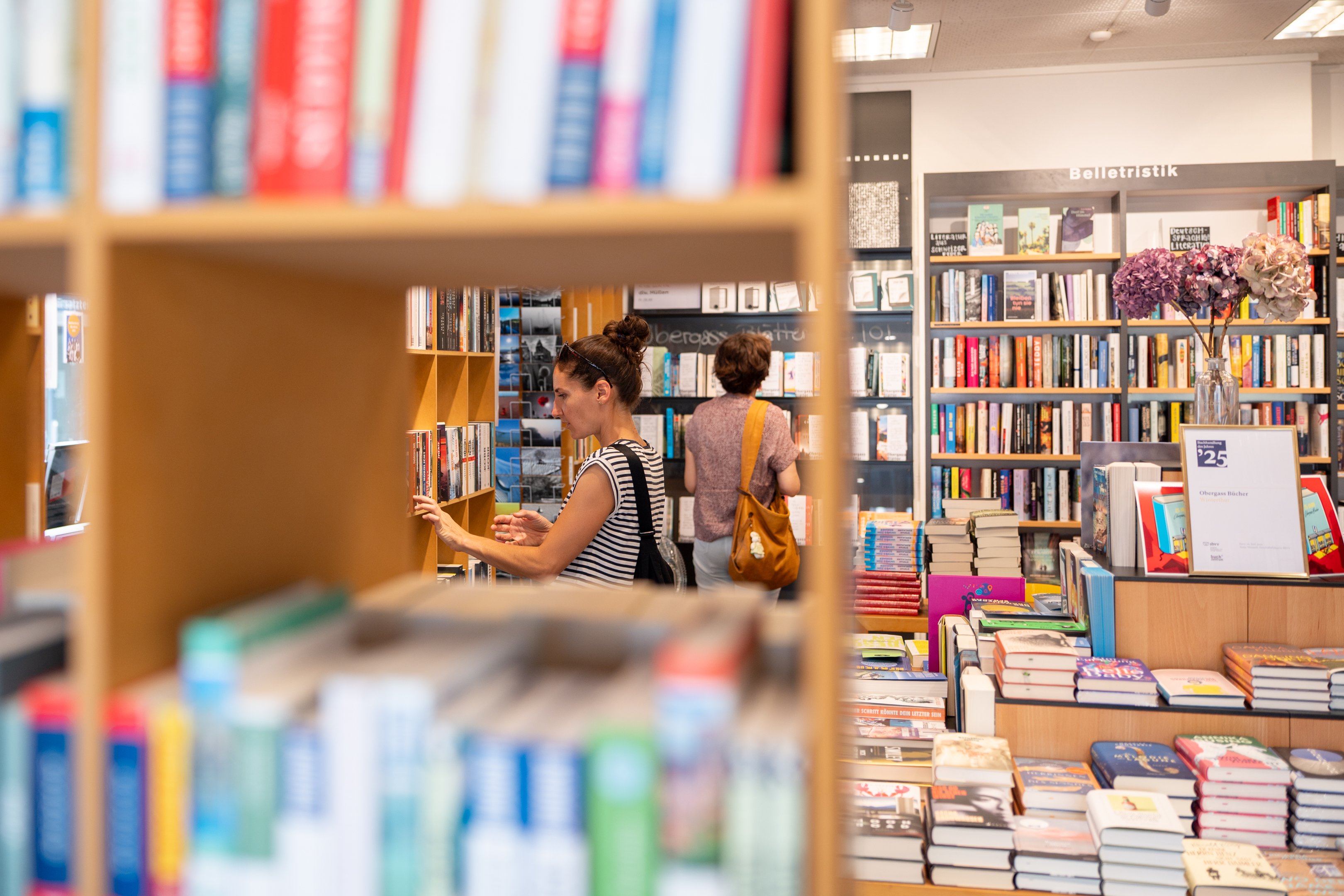 Deux femmes fouillant dans les rayons de la librairie.