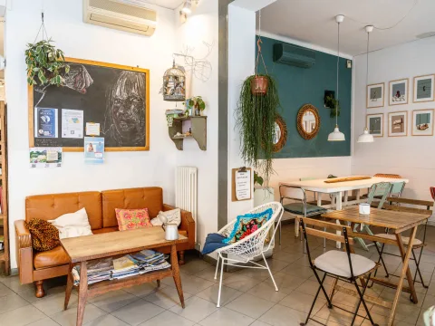 Cosy café with vintage furniture, plants and ornate details