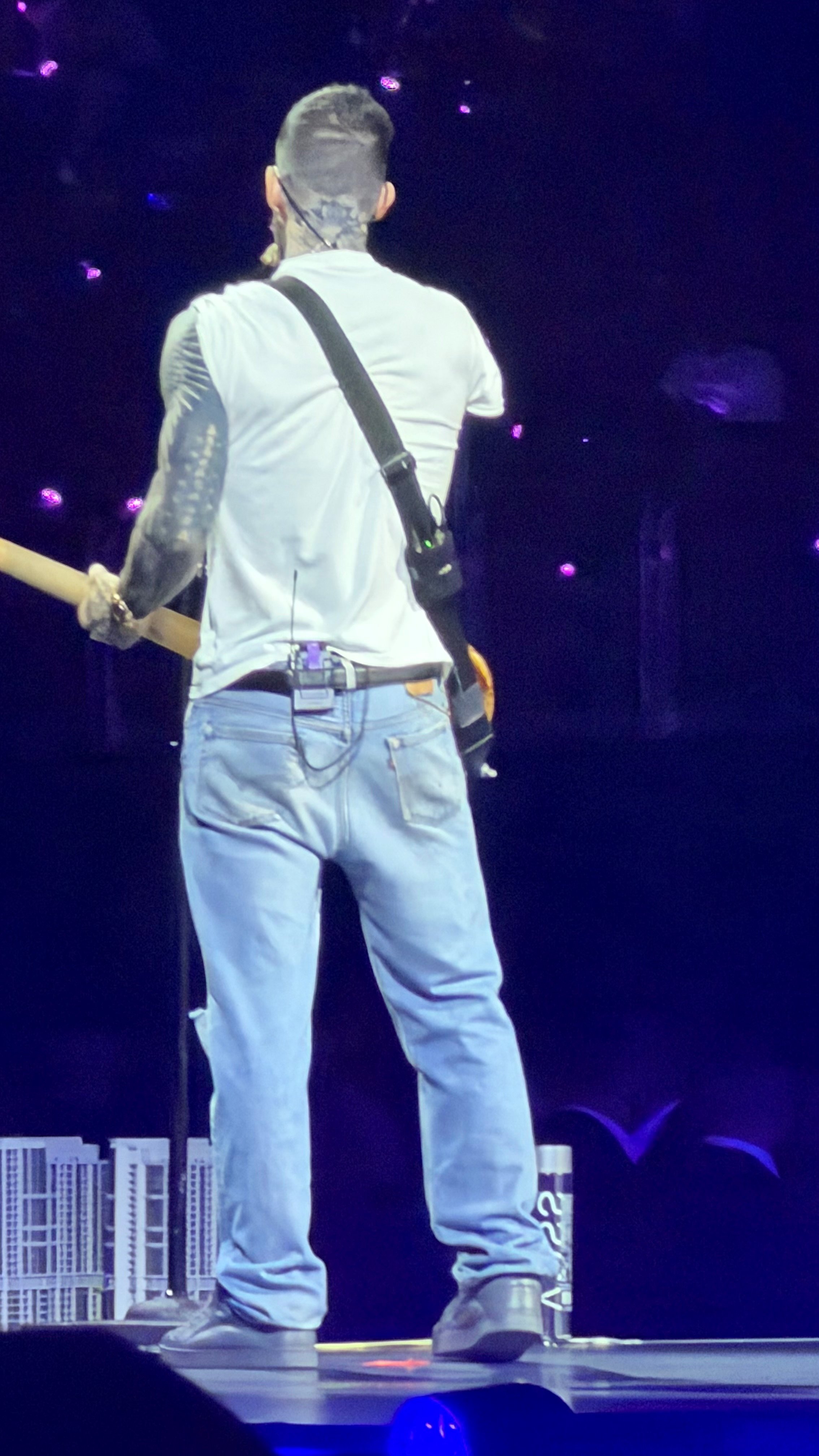Frontman Adam Levine onstage using his Spectera bodypack and in-ear monitors