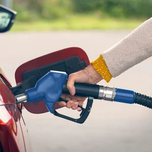 Person tankar E85 i en röd bil