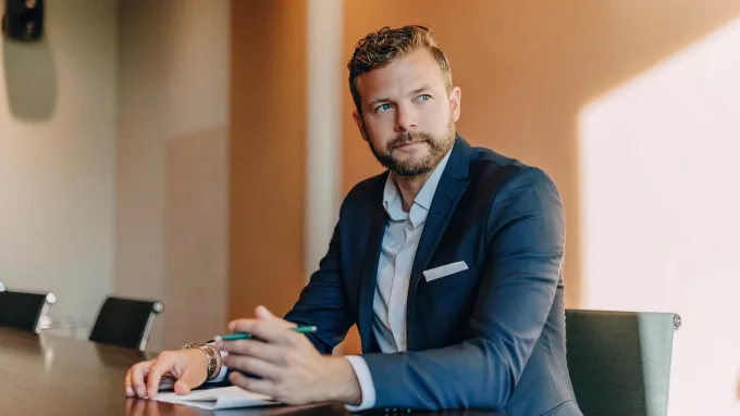 Male professional looking away in office board room