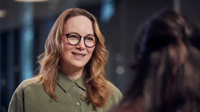 A woman talking to a colleague portrait